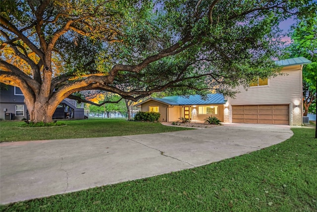 1704 Bluebonnet Ln, Kingsland, TX 78639 - view of front of home with concrete driveway, a standing seam roof, metal roof, a garage, and a front yard