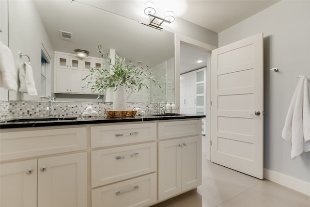 1704 Bluebonnet Ln, Kingsland, TX 78639 - full bath featuring decorative backsplash, tile patterned flooring, double vanity, and baseboards