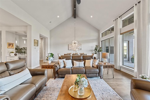 158 Baldovino Skwy, Lakeway, TX 78738 - living room featuring wood finished floors, beamed ceiling, high vaulted ceiling, baseboards, and a chandelier