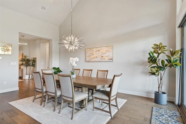 158 Baldovino Skwy, Lakeway, TX 78738 - dining room with hardwood / wood-style flooring, high vaulted ceiling, baseboards, and a chandelier