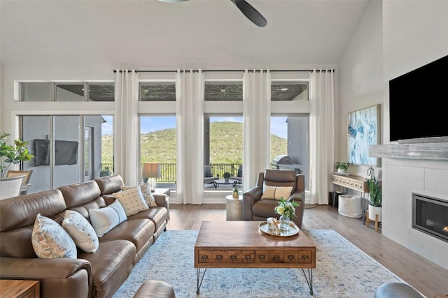 158 Baldovino Skwy, Lakeway, TX 78738 - living room with ceiling fan, a fireplace, and wood finished floors