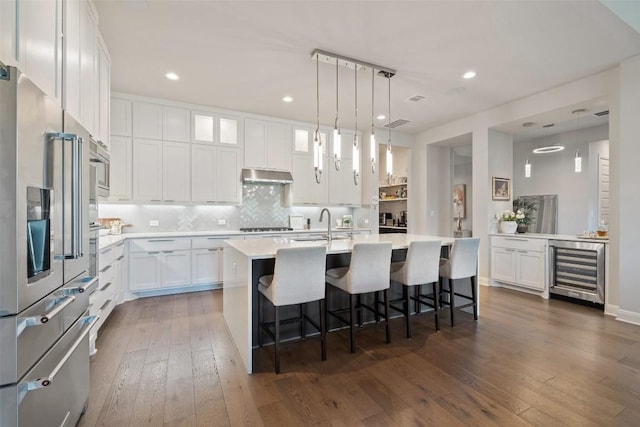 158 Baldovino Skwy, Lakeway, TX 78738 - kitchen with wine cooler, white cabinetry, dark wood-style floors, light countertops, and recessed lighting