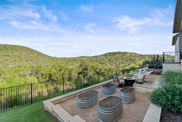 158 Baldovino Skwy, Lakeway, TX 78738 - view of patio / terrace with a fire pit, a view of trees, and a mountain view