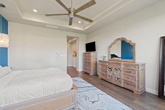 158 Baldovino Skwy, Lakeway, TX 78738 - bedroom with a tray ceiling, wood finished floors, recessed lighting, and baseboards