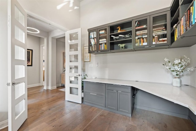 158 Baldovino Skwy, Lakeway, TX 78738 - bar featuring french doors, hardwood / wood-style floors, built in desk, and baseboards