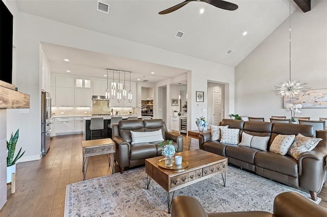158 Baldovino Skwy, Lakeway, TX 78738 - living room with a chandelier, ceiling fan, light wood-type flooring, recessed lighting, and high vaulted ceiling