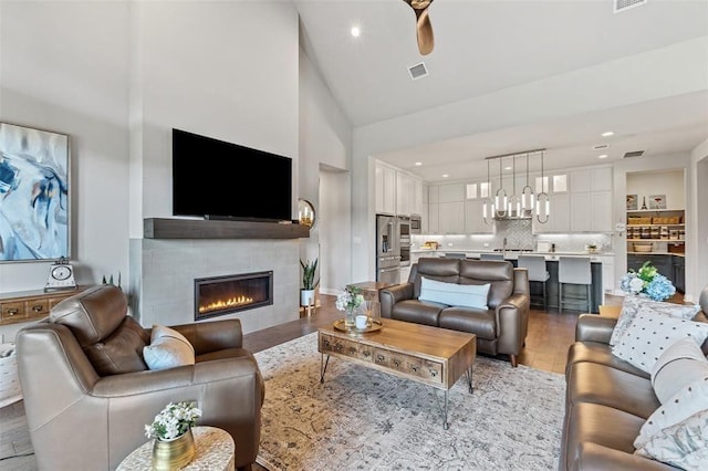 158 Baldovino Skwy, Lakeway, TX 78738 - living room featuring a tile fireplace, light wood-style floors, recessed lighting, high vaulted ceiling, and ceiling fan