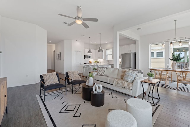 425 Dayridge Dr, Dripping Springs, TX 78620 - living area featuring light wood-style floors, ceiling fan, and baseboards