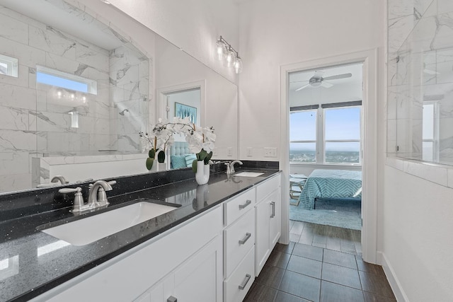 425 Dayridge Dr, Dripping Springs, TX 78620 - ensuite bathroom with a marble finish shower, double vanity, ceiling fan, and tile patterned floors