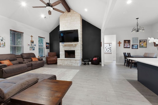 110 Lakecliff Cv, Kingsland, TX 78639 - living room with beamed ceiling, a ceiling fan, a chandelier, a fireplace, and light wood-style floors