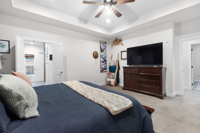 110 Lakecliff Cv, Kingsland, TX 78639 - carpeted bedroom with a raised ceiling, baseboards, ceiling fan, and ensuite bath