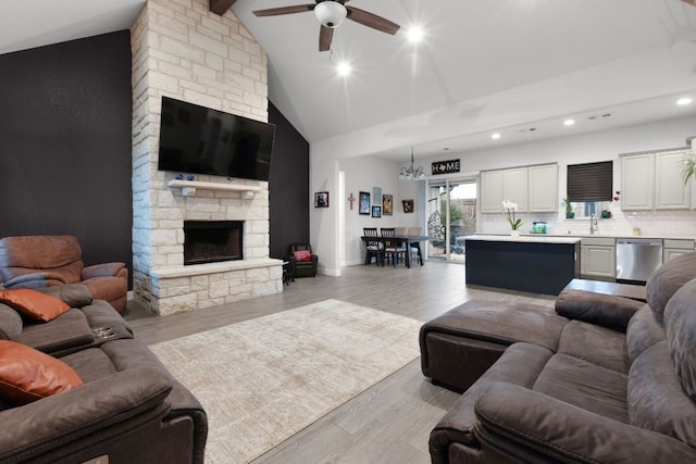 110 Lakecliff Cv, Kingsland, TX 78639 - living room featuring ceiling fan, recessed lighting, a fireplace, high vaulted ceiling, and light wood-style flooring