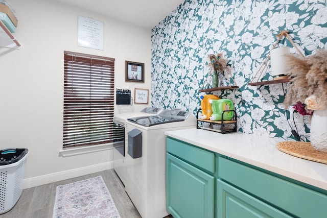 110 Lakecliff Cv, Kingsland, TX 78639 - laundry room featuring washing machine and dryer, baseboards, cabinet space, light wood-type flooring, and wallpapered walls