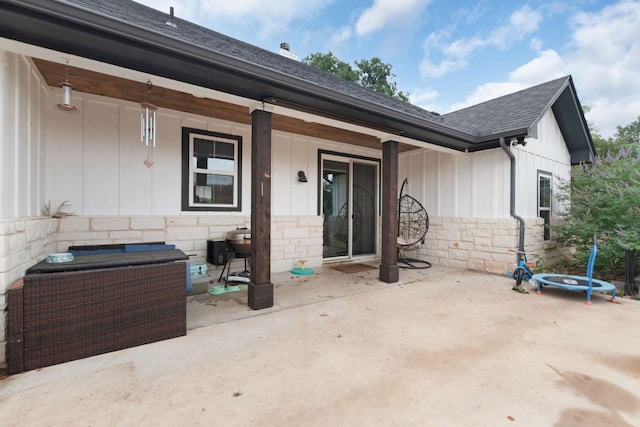 110 Lakecliff Cv, Kingsland, TX 78639 - rear view of property with board and batten siding, stone siding, a shingled roof, and a patio area