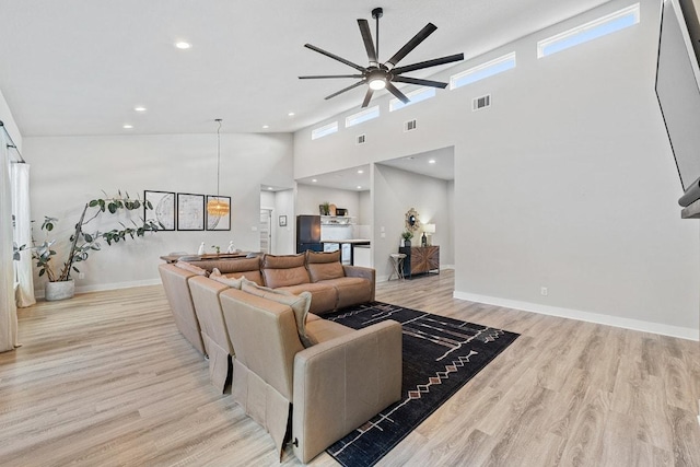 20702 Post Oak Dr, Lago Vista, TX 78645 - living area featuring ceiling fan, wood finished floors, a high ceiling, baseboards, and recessed lighting