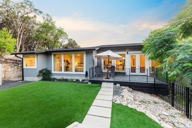 20702 Post Oak Dr, Lago Vista, TX 78645 - back of house at dusk featuring stucco siding and a deck