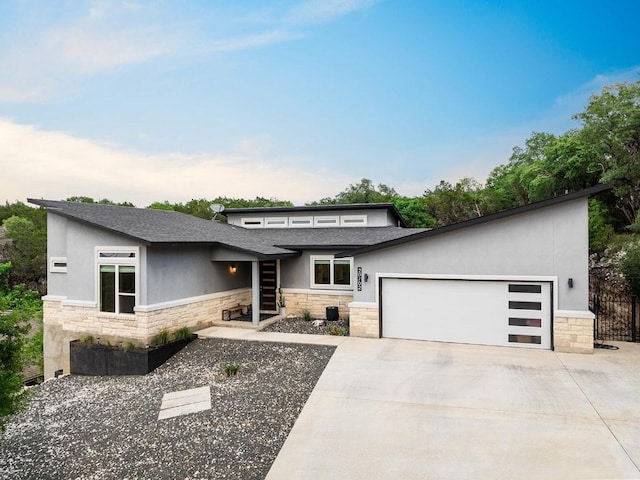 20702 Post Oak Dr, Lago Vista, TX 78645 - view of front of property with stone siding, stucco siding, an attached garage, and driveway