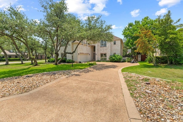 205 Champion Dr, Lakeway, TX 78734 - view of front of house featuring concrete driveway, a front yard, and a garage