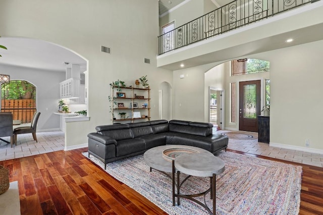 205 Champion Dr, Lakeway, TX 78734 - living area featuring a high ceiling, arched walkways, and wood finished floors