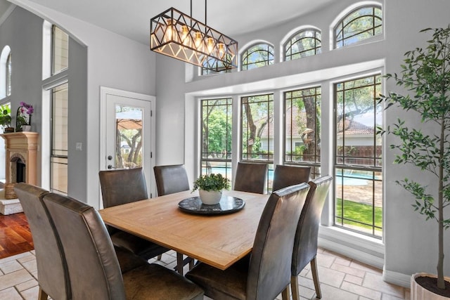 205 Champion Dr, Lakeway, TX 78734 - dining area featuring stone tile flooring and a towering ceiling