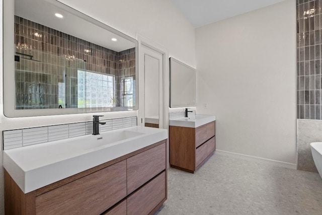 205 Champion Dr, Lakeway, TX 78734 - full bathroom featuring two vanities, a freestanding bath, and recessed lighting