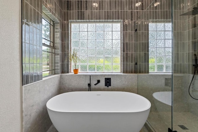 205 Champion Dr, Lakeway, TX 78734 - full bathroom with a freestanding tub, tiled shower, plenty of natural light, and a textured wall