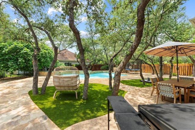205 Champion Dr, Lakeway, TX 78734 - fenced backyard with a trampoline, a patio area, and outdoor dining space