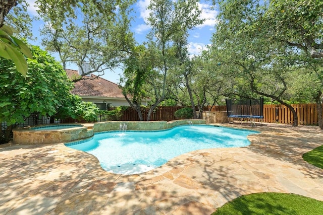 205 Champion Dr, Lakeway, TX 78734 - view of swimming pool featuring a trampoline, a fenced backyard, a patio, and a pool with connected hot tub