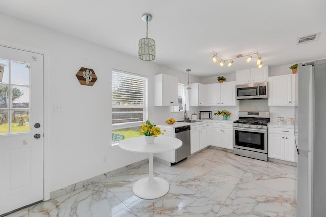 18400 Sun Haven Cv, Elgin, TX 78621 - kitchen with stainless steel appliances, light marble finish floors, a sink, and white cabinetry