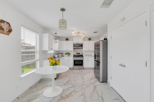 18400 Sun Haven Cv, Elgin, TX 78621 - kitchen with appliances with stainless steel finishes, light marble finish floors, light countertops, and white cabinets