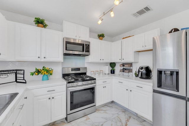 18400 Sun Haven Cv, Elgin, TX 78621 - kitchen with stainless steel appliances, light marble finish flooring, white cabinets, and light countertops