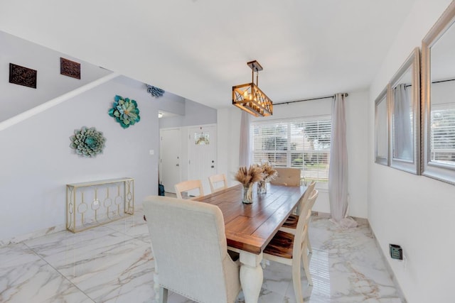 18400 Sun Haven Cv, Elgin, TX 78621 - dining room featuring light marble finish flooring and a chandelier
