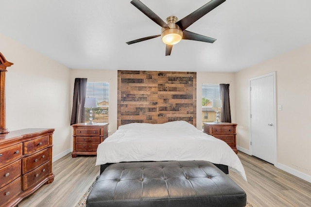 18400 Sun Haven Cv, Elgin, TX 78621 - bedroom with multiple windows, baseboards, and light wood finished floors