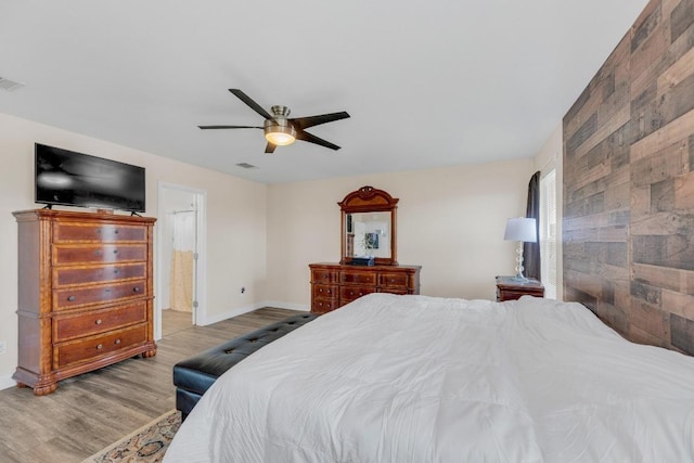 18400 Sun Haven Cv, Elgin, TX 78621 - bedroom featuring wood finished floors, baseboards, a ceiling fan, and ensuite bathroom