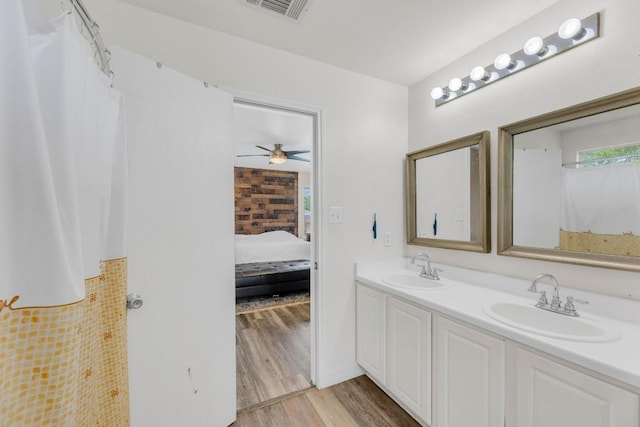 18400 Sun Haven Cv, Elgin, TX 78621 - bathroom with wood finished floors, ensuite bath, double vanity, and ceiling fan