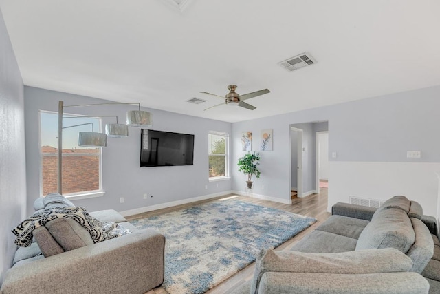 18400 Sun Haven Cv, Elgin, TX 78621 - living room featuring wood finished floors, ceiling fan, and baseboards