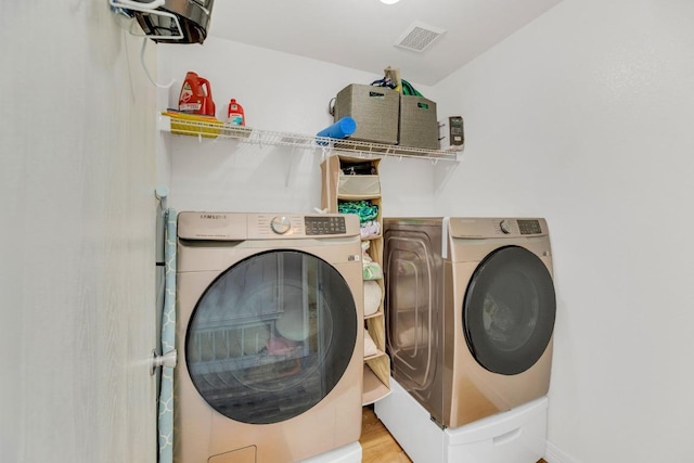 18400 Sun Haven Cv, Elgin, TX 78621 - washroom featuring independent washer and dryer and wood finished floors
