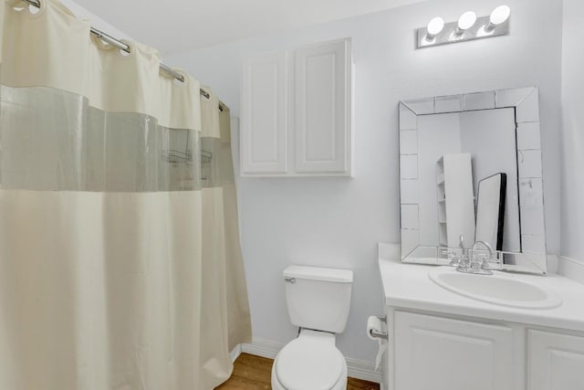 18400 Sun Haven Cv, Elgin, TX 78621 - full bath with toilet, vanity, baseboards, wood finished floors, and a shower with curtain