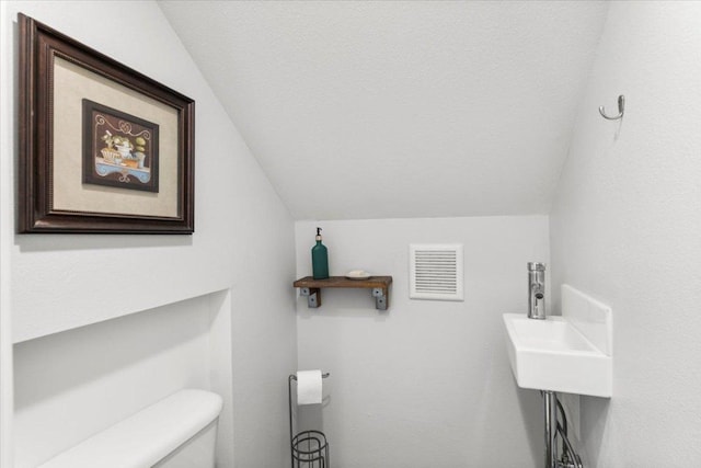 103 Lei Ct, Bastrop, TX 78602 - bathroom with toilet and vaulted ceiling