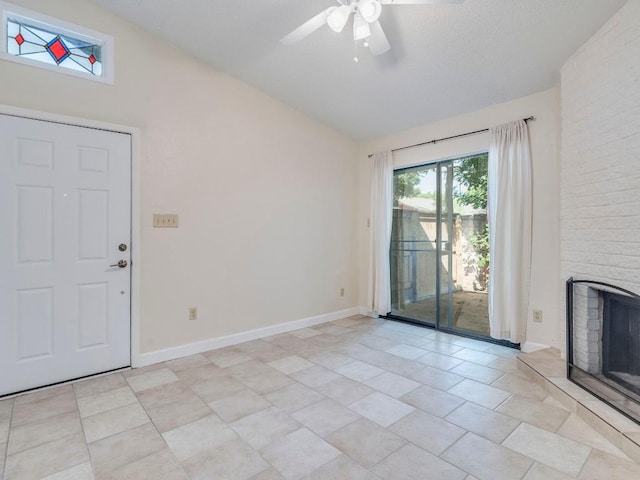 3815 Menchaca Rd Unit 19, Austin, TX 78704 - unfurnished living room featuring vaulted ceiling, ceiling fan, a fireplace, baseboards, and light tile patterned floors