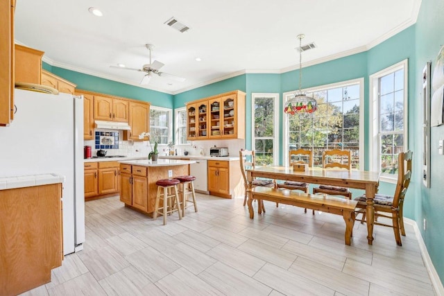 418 Grace Ln, Austin, TX 78746 - kitchen with white appliances, light countertops, backsplash, a ceiling fan, and glass insert cabinets