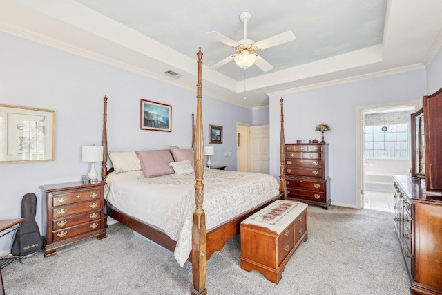 418 Grace Ln, Austin, TX 78746 - bedroom with a raised ceiling, light colored carpet, ornamental molding, connected bathroom, and a ceiling fan