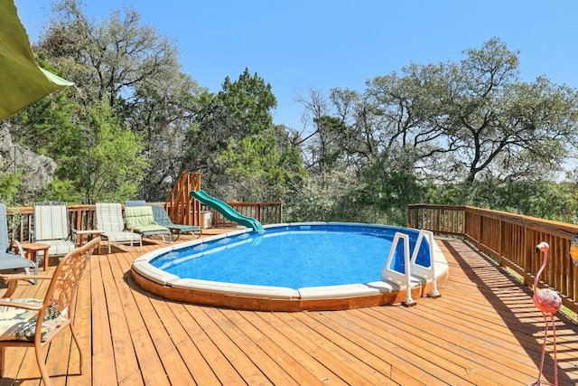 418 Grace Ln, Austin, TX 78746 - view of pool featuring view of scattered trees, a water slide, and a deck