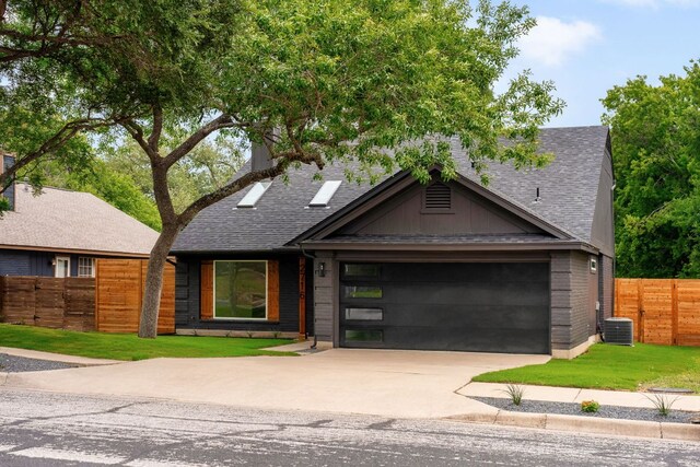 2716 Gettysburg Dr, Austin, TX 78745 - view of front of home featuring a garage, concrete driveway, central AC unit, and a shingled roof