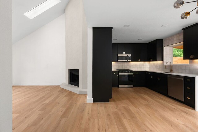 2716 Gettysburg Dr, Austin, TX 78745 - kitchen with appliances with stainless steel finishes, dark cabinets, light countertops, a sink, and decorative backsplash