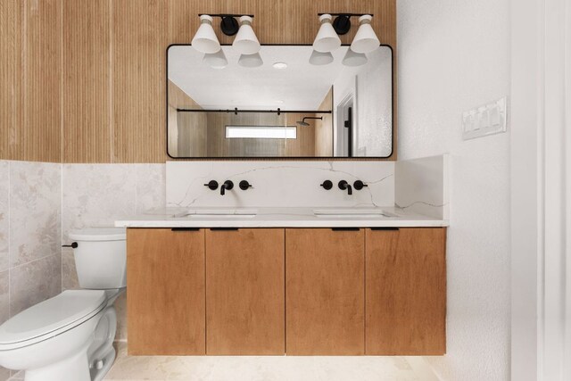 2716 Gettysburg Dr, Austin, TX 78745 - bathroom with vanity, toilet, and tile walls