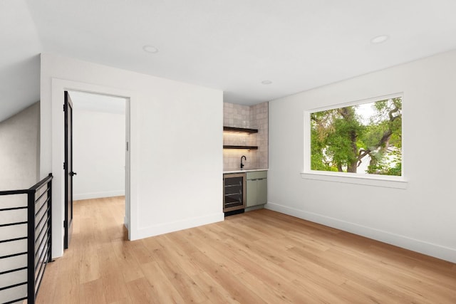 2716 Gettysburg Dr, Austin, TX 78745 - indoor wet bar featuring wine cooler, light wood-type flooring, and baseboards