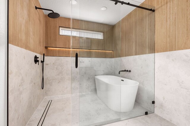 2716 Gettysburg Dr, Austin, TX 78745 - bathroom with tiled shower and a freestanding tub