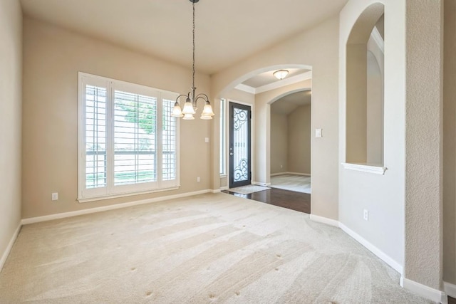 20125 Chayton Cir, Pflugerville, TX 78660 - unfurnished dining area with carpet flooring, arched walkways, a chandelier, and baseboards