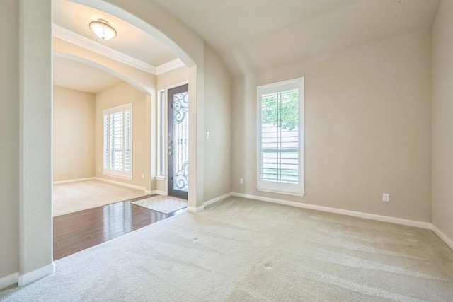 20125 Chayton Cir, Pflugerville, TX 78660 - carpeted foyer entrance with arched walkways, baseboards, and ornamental molding